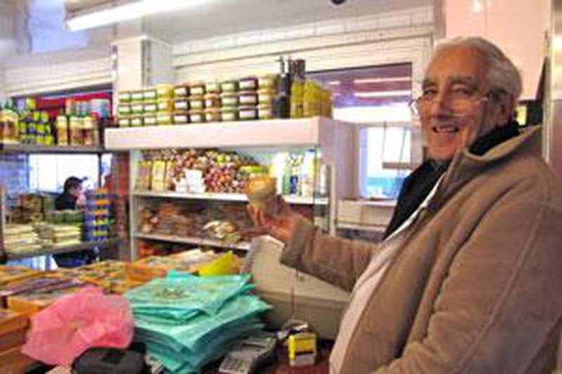 Aziz Hamdame, owner of the Boucherie de la Place, holds a jar of halal foie gras.