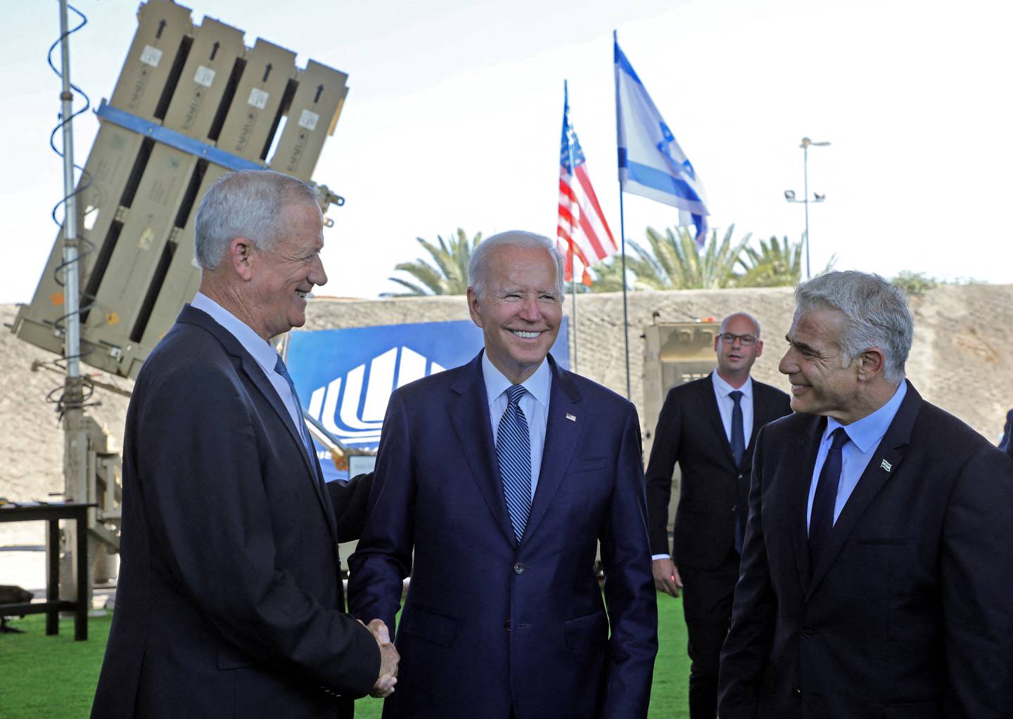 US President Joe Biden, Israeli Prime Minister Yair Lapid and Israeli Defence Minister Benny Gantz stand in front of Israel's Iron Dome defence system in Lod last week. Reuters