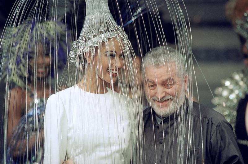 With a model wearing a white dress and metallic headpiece during his autumn/winter 1992 haute couture show in Paris. AP Photo 
