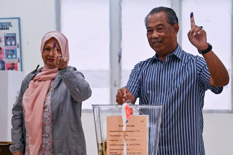 Mr Muhyiddin shows his inked finger as he casts his ballot at a polling station in Muar, a city in Malaysia's Johor state. AFP