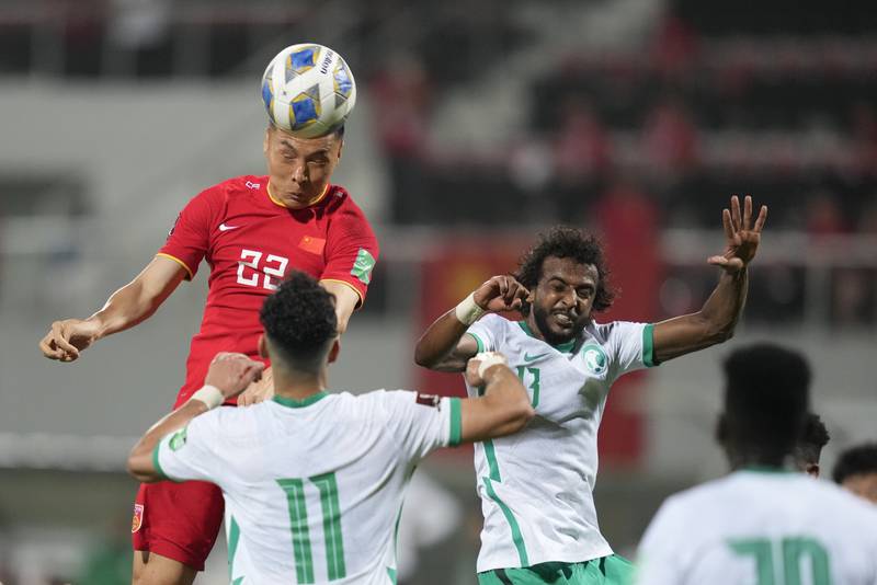 China's Dabao Yu heads the ball during the World Cup 2022 qualifier against Saudi Arabia in Sharjah. AP
