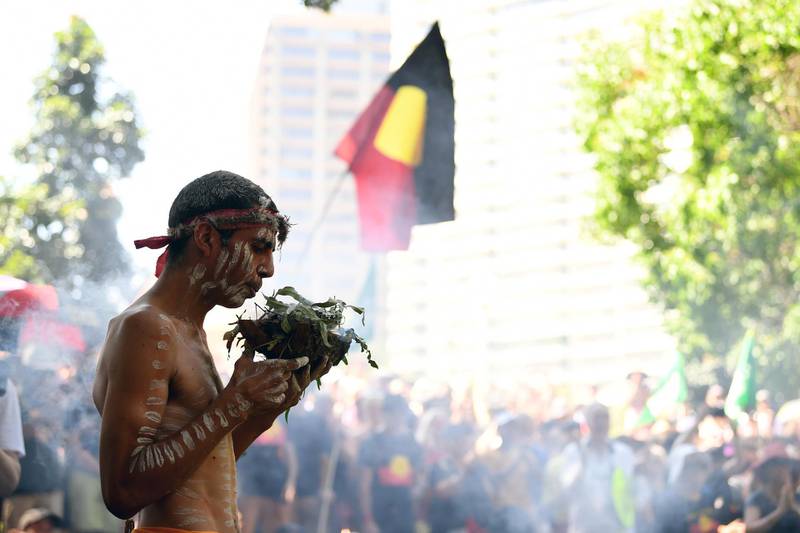 A person participates in an Indigenous smoking ceremony during an 'Invasion Day' Rally on Australia Day in Sydney. EPA