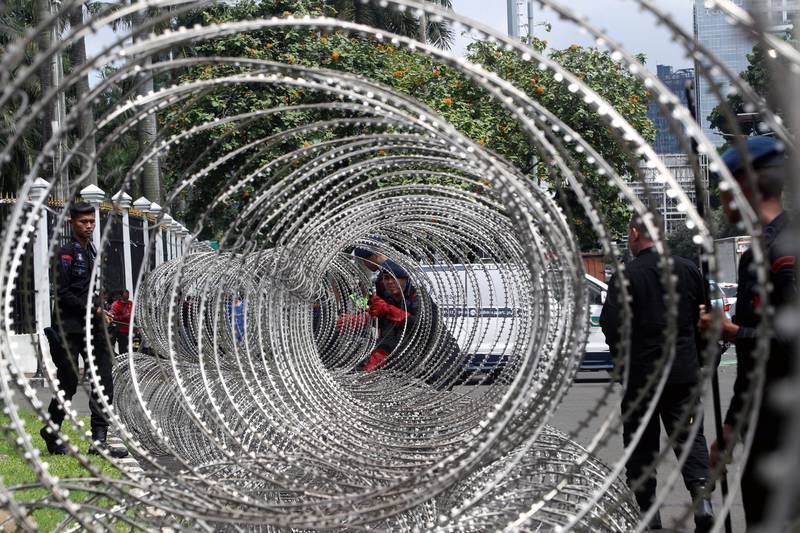 Indonesian police set up a barbed wire fence before a protest against the Omnibus Law in Jakarta. EPA