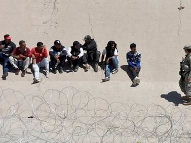 A group of migrants remains on one side of the border with the United States guarded by National Guard personnel in Juarez City, Chihuahua, Mexico. EPA