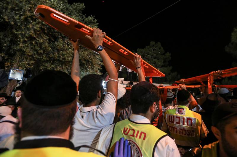 Medics and rescue workers carry stretchers at the Lag BaOmer event in Mount Meron, northern Israel, where fatalities were reported among thousands of ultra-Orthodox Jews gathered at the tomb of a 2nd-century sage for annual commemorations that include all-night prayer and dance. Reuters