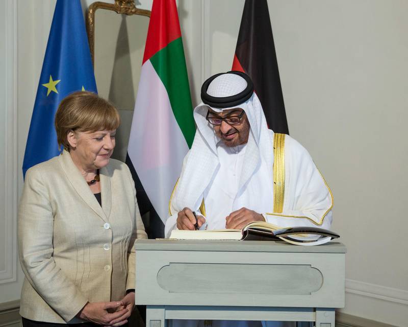MESEBERG, BRANDENBURG, GERMANY - May 9, 2016: HH Sheikh Mohamed bin Zayed Al Nahyan, Crown Prince of Abu Dhabi and Deputy Supreme Commander of the UAE Armed Forces (R), signs the guest book at Schloss Meseberg palace, prior to a dinner reception hosted by Angela Merkel, Chancellor of Germany (L). 
( Ryan Carter / Crown Prince Court - Abu Dhabi )
--- *** Local Caption ***  20160509RC_C146204.jpg