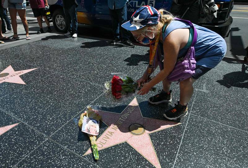 A fan places flowers on the actress's star in Hollywood. AFP
