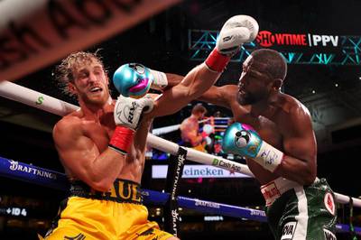 Floyd Mayweather lands a punch on Logan Paul during their exhibition boxing bout at Hard Rock Stadium. AFP