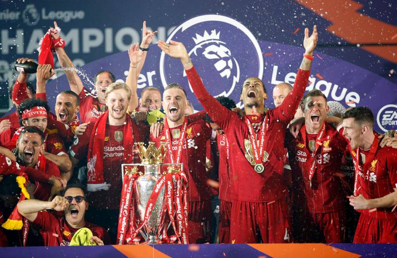 Liverpool players celebrate with the Premier League trophy. Getty