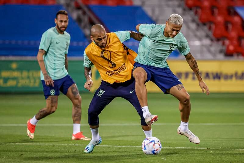 Brazil's players Dani Alves and Richarlison train as Neymar looks on. EPA