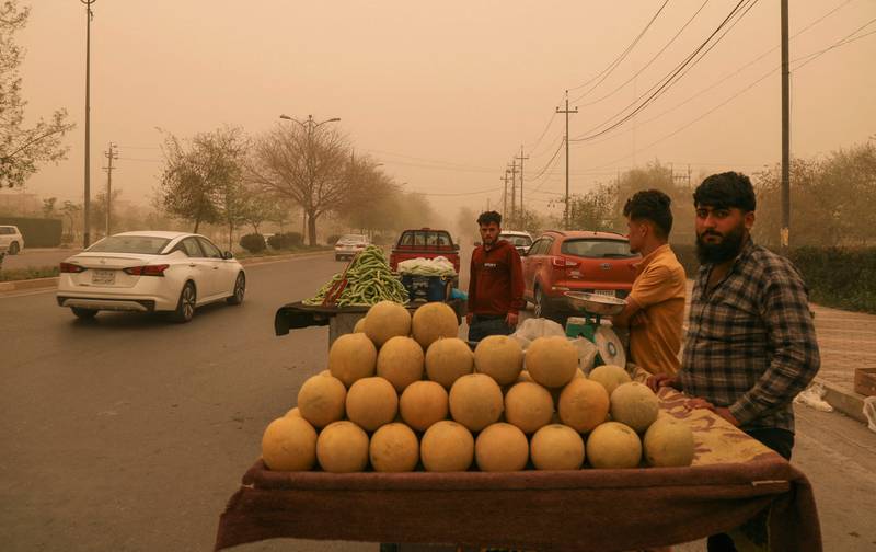 Street vendors defy the sandstorm to ply their trade at a roadside stall in Arbil, in northern Iraq.