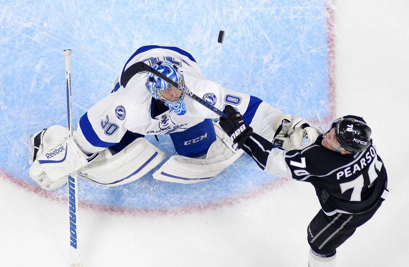 Los Angeles Kings left wing Tanner Pearson, right, tries to score on Tampa Bay Lightning goalie Ben Bishop during the third period of an NHL hockey game in Los Angeles. The Kings won 3-1. Mark J Terrill / AP