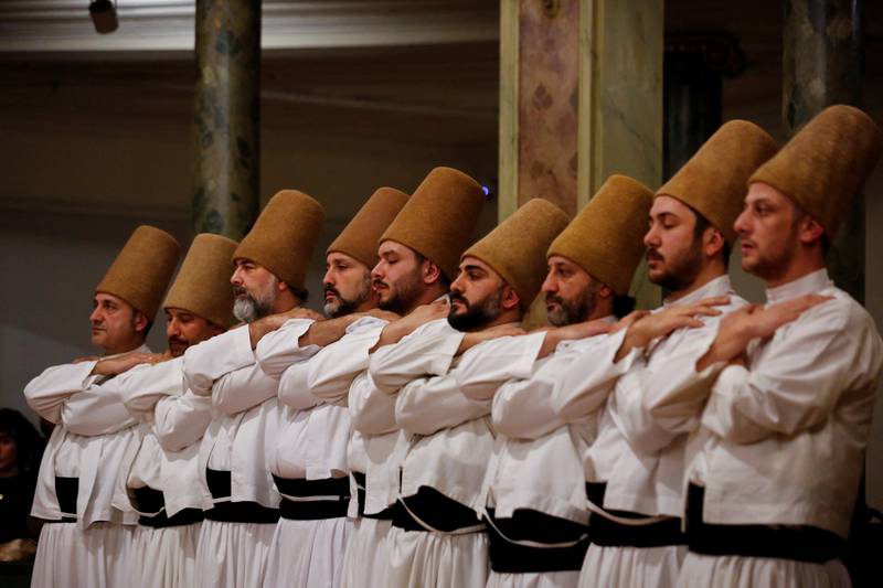 Dancers also wear tall conical felt hats called sikke, ranging from brown to gray to black depending on their sect.