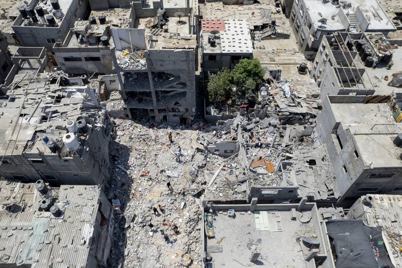 Palestinians search through the rubble of a building in which Khaled Mansour, a top Islamic Jihad militant, was killed in an Israeli air strike on Sunday, in Rafah, the southern Gaza Strip. AP