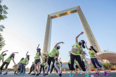 Dubai, United Arab Emirates - Participants stretching before running at the Dubai Run, The Frame Zabeel Park.  Leslie Pableo for The National