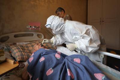 A medical worker takes a swab from a resident during home visits in Wuhan, the epicentre of China's coronavirus outbreak, in the central Hubei province, on May 14, 2020. AP