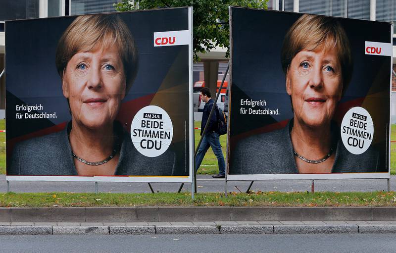 Election posters of German Chancellor Angela Merkel stand at a main street in Frankfurt, Germany, Wednesday, Sept. 20, 2017. German elections will be held on upcoming Sunday. The slogan reads "successful for Germany". (AP Photo/Michael Probst)