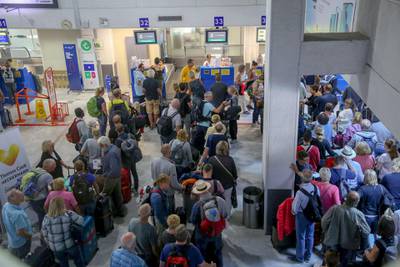 People line up in front of a counter of Thomas Cook at the Heraklion airport on the island of Crete, Greece. REUTERS