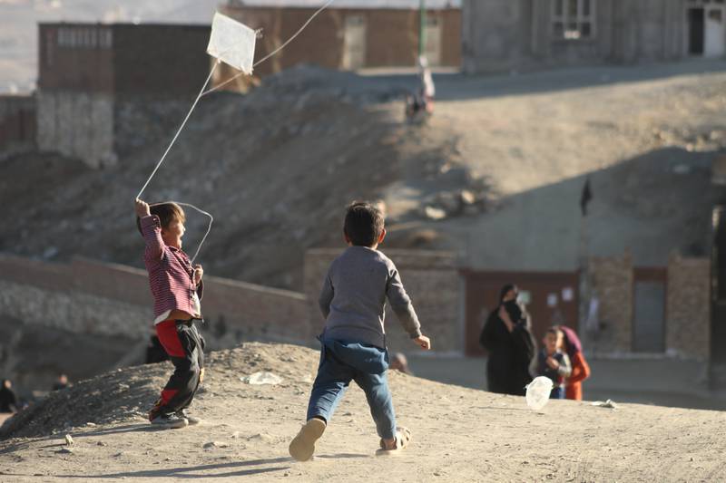 Children play with kites in Kunduz, where Fazal Karim Aimaq and his family once lived. Photo: Farid Ershad on Unsplash