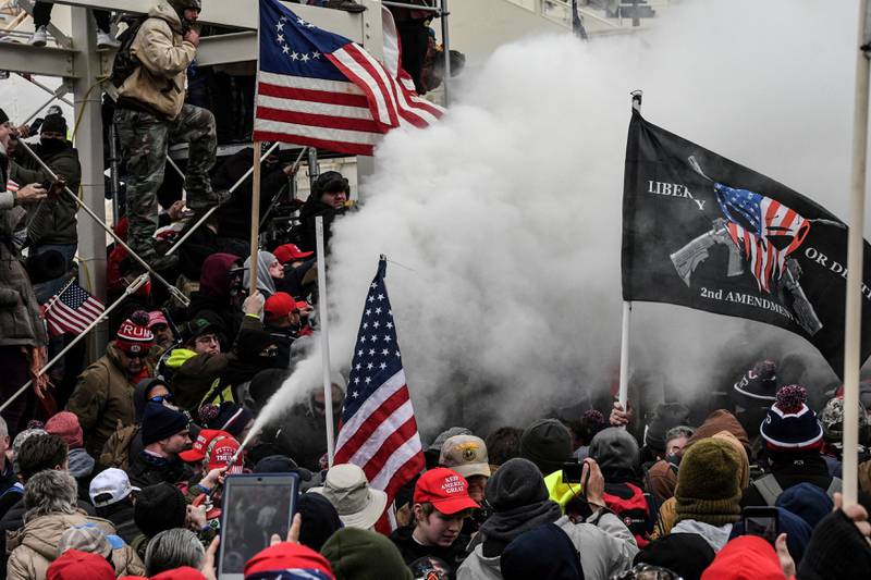 A Trump supporter sprays smoke. Reuters
