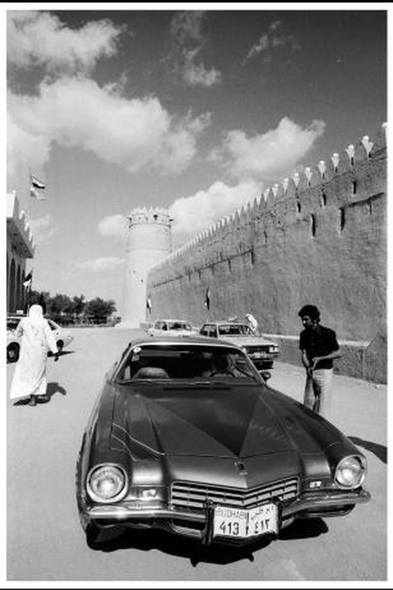 Abu Dhabi 1974. A car and man outside the walls of Qasr Al Hosn Fort.Photograph by Jack Burlot