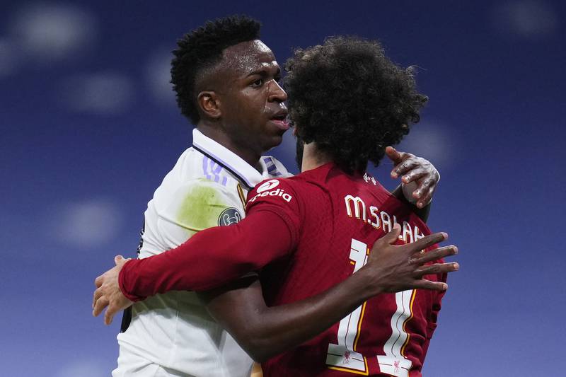 Real's Vinicius and Mohamed Salah embrace. AP