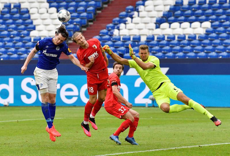 Schalke 04's Michael Gregoritsch in action with FC Augsburg's Tin Jedvaj and Andreas Luthe. Reuters