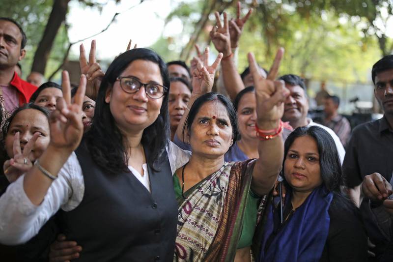Asha Devi and her lawyer flash victory signs after the executions on March 20, 2020. AP Photo