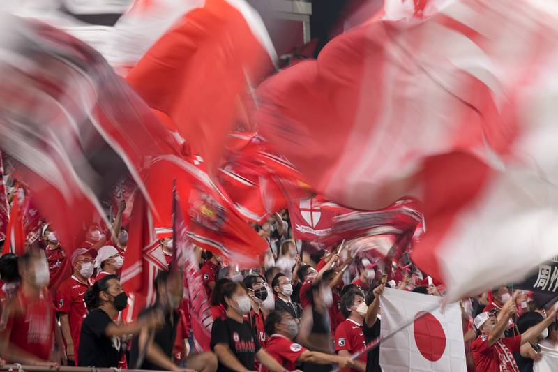 Supporters of Japan's Urawa Red Diamonds cheer during the AFC Champions League semi-final match between their team and South Korea's Jeonbuk Hyundai Motors, at Saitama Stadium, near Tokyo. AP Photo