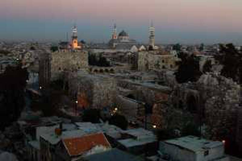 The ancient sector of Damascus, known as the "old city" stands with a backdrop of the Umayyad Mosque and its three minarettes at sunset, Nov. 16, 2002. Damascenes claim that the old city, settled as early as 1500 BC, is the oldest continuously inhabited city in the world. (AP Photo/John Moore)