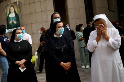 A nun reacts during a vigil for the victims of the massive explosion, in Beirut. Reuters