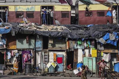 Poverty levels in India remain extremely high despite the swift economic growth of the past two-and-a-half decades. Here, Indians are seen living in slums near the Reay Road railway station in Mumbai. Dhiraj Singh / Bloomberg
