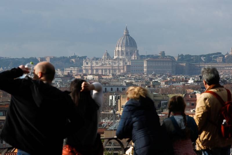 Saint Peter's Dome can be seen in the background in Rome as people gather at the Pincio Terrace a day after the worsening health of former Pope Benedict was announced. Reuters