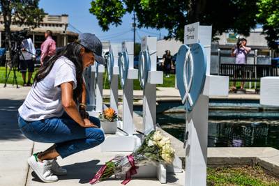 Meghan places flowers at a makeshift memorial outside Uvalde County Courthouse in Texas, in May, after the shooting of 19 children at Uvalde elementary school. AFP