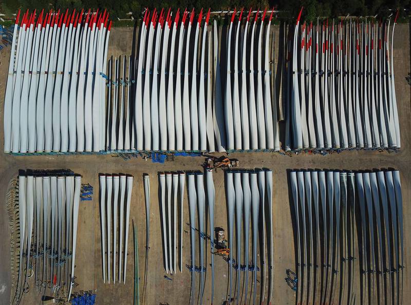 Workers check the quality of newly-manufactured wind turbine blades at a factory in Lianyungang in China's eastern Jiangsu province. AFP