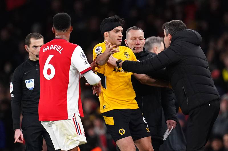 Wolves' Raul Jimenez is pushed back on the pitch by manager Bruno Lage after confusion for being shown a yellow card. PA