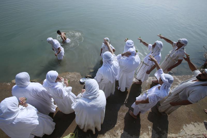 Followers of the ancient Sabean Mandaean religious sect pray alongside the Tigris River during the Prosperity Day celebration in central Baghdad, Iraq. Mandaeism follows the teachings of John the Baptist and its rites revolve around water and prosperity. AP 