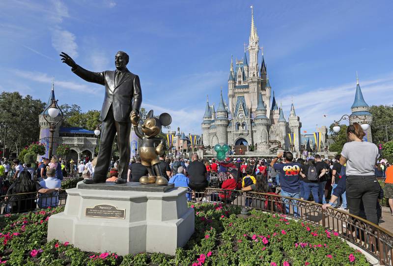 A statue of Walt Disney and Micky Mouse near the Cinderella Castle at the Magic Kingdom of Walt Disney World in Lake Buena Vista, Florida. AP