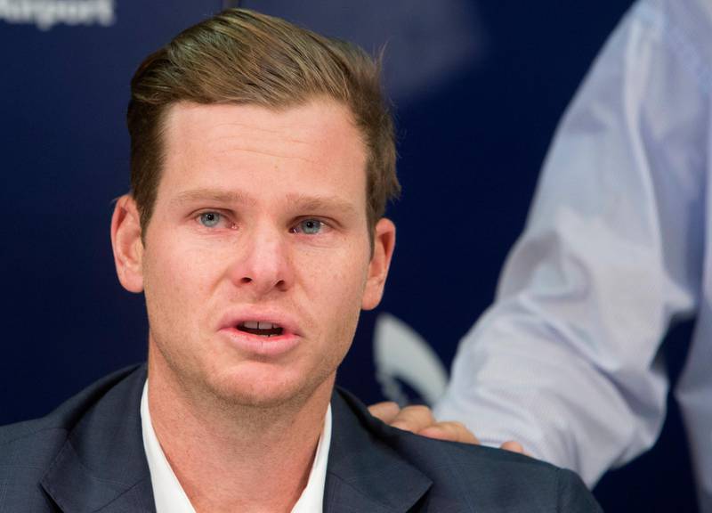 Former Australian cricket captain Steve Smith speaks to the media as his father, Peter, rests his hand on Steve's shoulder in Sydney, Thursday, March 29, 2018, after being sent home from South Africa following a ball tampering scandal. Smith and vice-captain David Warner were banned for 12 months while young batsman Cameron Bancroft received 9 months after an investigation into the Australian cricket team's cheating scandal identified Warner as the instigator of the ball tampering plan that unraveled in South Africa. (AP Photo/Steve Christo)