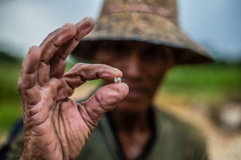 A miner shows a raw diamond found during a sieving process at a village in Banjarbaru, Indonesia. AFP