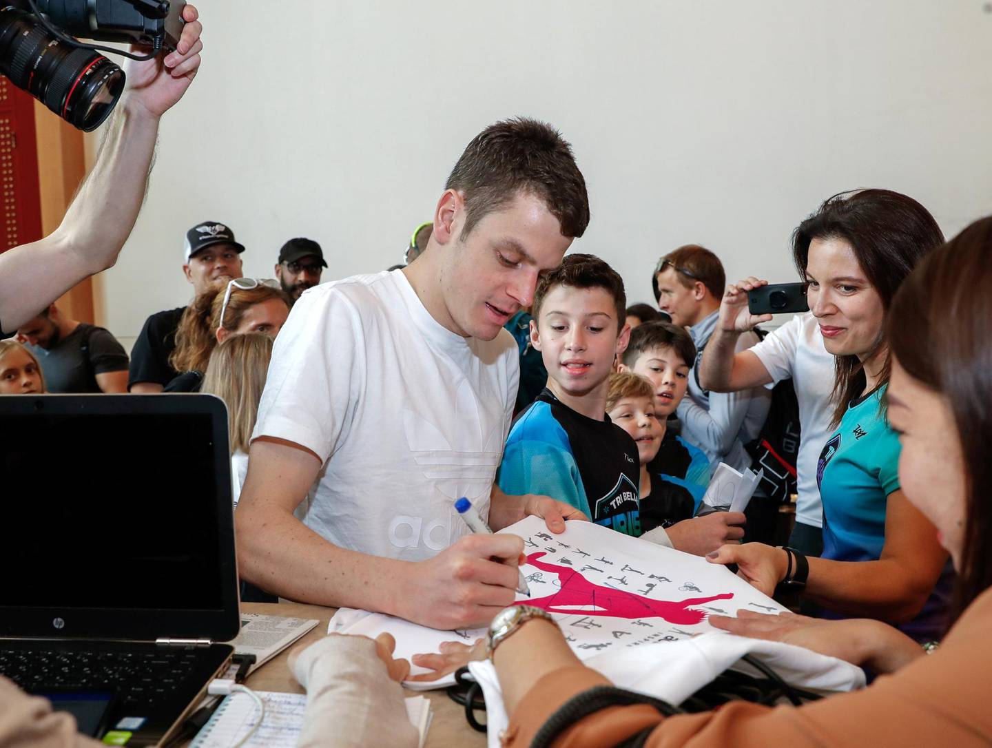 Abu Dhabi, UAE, February 28, 2018.   Pre-race conference , ITU World Triathlon AbuDhabi.  (center)  Jonathan Brownlee signs some autographs for his fans after the press conference.Victor Besa / The NationalSportsReporter:  Amith Passela