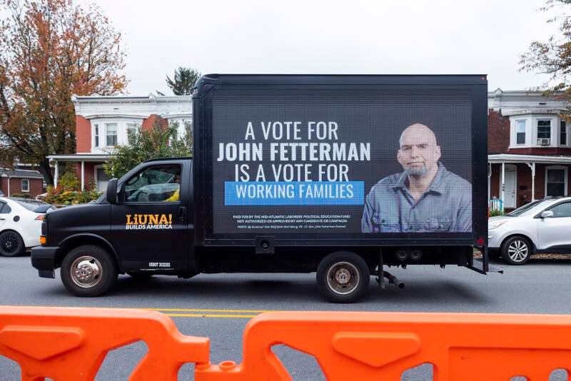 A truck promoting Mr Fetterman drives by the site of his debate with Dr Oz in Harrisburg. EPA