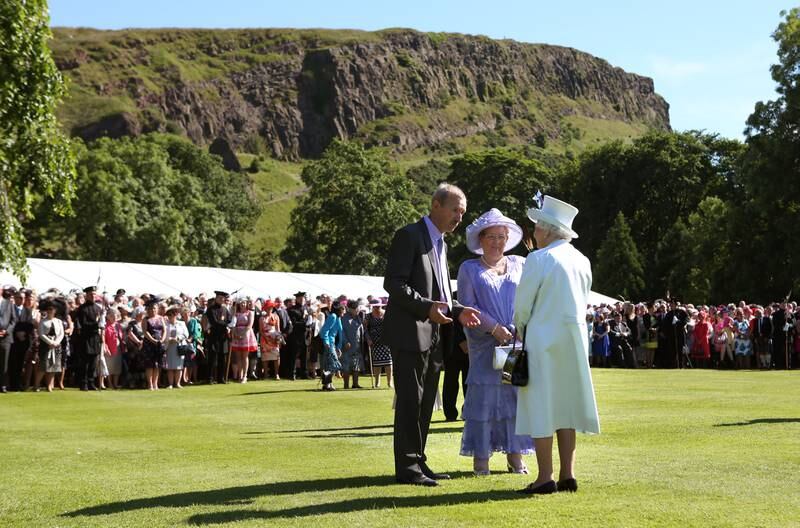 The queen meets guests at a garden party at the Palace of Holyroodhouse in Edinburgh, in 2014.