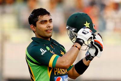 FILE - In this March 8, 2014, file photo, Pakistan's Umar Akmal celebrates against Sri Lanka during their Asia Cup final cricket match in Dhaka, Bangladesh. The Pakistan Cricket Board has suspended batsman Umar Akmal under its anti-corruption code hours before the start of its domestic Twenty20 tournament in Karachi. (AP Photo/A.M. Ahad, File)