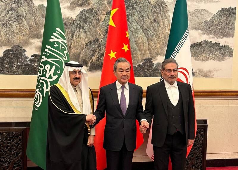 China's top diplomat Wang Yi is flanked by Saudi Minister of State and national security adviser Musaed bin Al Aiban, left, and Iranian Admiral Ali Shamkhani, secretary of the Supreme National Security Council, in Beijing on Friday. Reuters