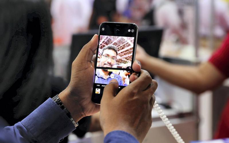 DUBAI,  UNITED ARAB EMIRATES , SEPTEMBER 24 – 2019 :- Visitor looking the new iphone 11 at the Emax electronic stand during the Gitex Shopper held at Dubai World Trade Centre in Dubai. ( Pawan Singh / The National ) For News. Story by Patrick