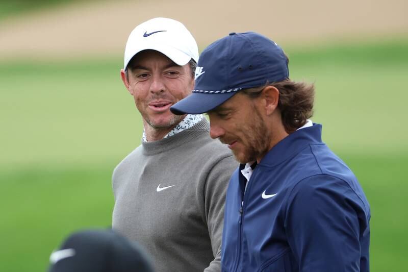 Rory McIlroy of Northern Ireland and Tommy Fleetwood of England smile on course during Day Two of the Hero Dubai Desert Classic at Emirates Golf Club on January 27, 2023. Getty Images