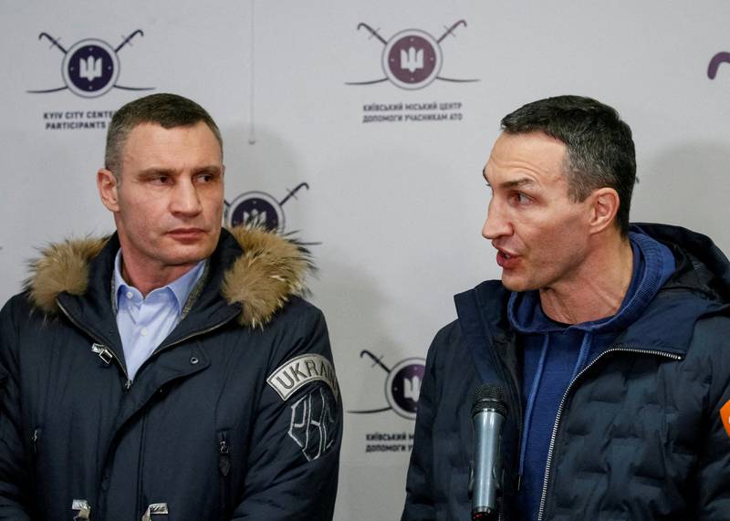 Mayor of Kyiv Vitaly Klitschko, left, a former heavyweight boxing champion, and his brother, heavyweight boxing world champion Wladimir Klitschko, speak at the opening of the first Ukrainian Territorial Defence Forces recruitment centre in central Kyiv. Reuters