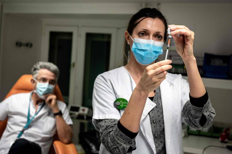 A nurse prepares a dose of the Pfizer-BioNTech vaccine at the Croix Rousse Hospital in Lyon, France. AFP