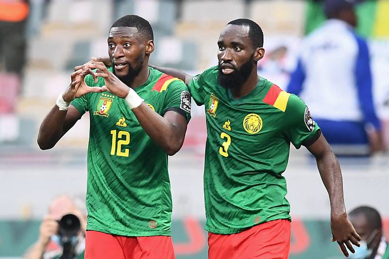 Cameroon's forward Karl Toko Ekambi (L) celebrates with Cameroon's forward Moumi Ngamaleu after scoring his team's first goal during the Africa Cup of Nations (CAN) 2021 quarter final football match between Gambia and Cameroon at the Japoma Stadium in Douala on January 29, 2022.  (Photo by CHARLY TRIBALLEAU  /  AFP)